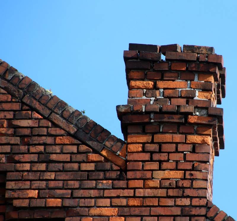 Signs Your Lake Dallas Home Needs a Chimney Inspection Damaged chimney on an Lake Dallas home showing cracks and missing mortar